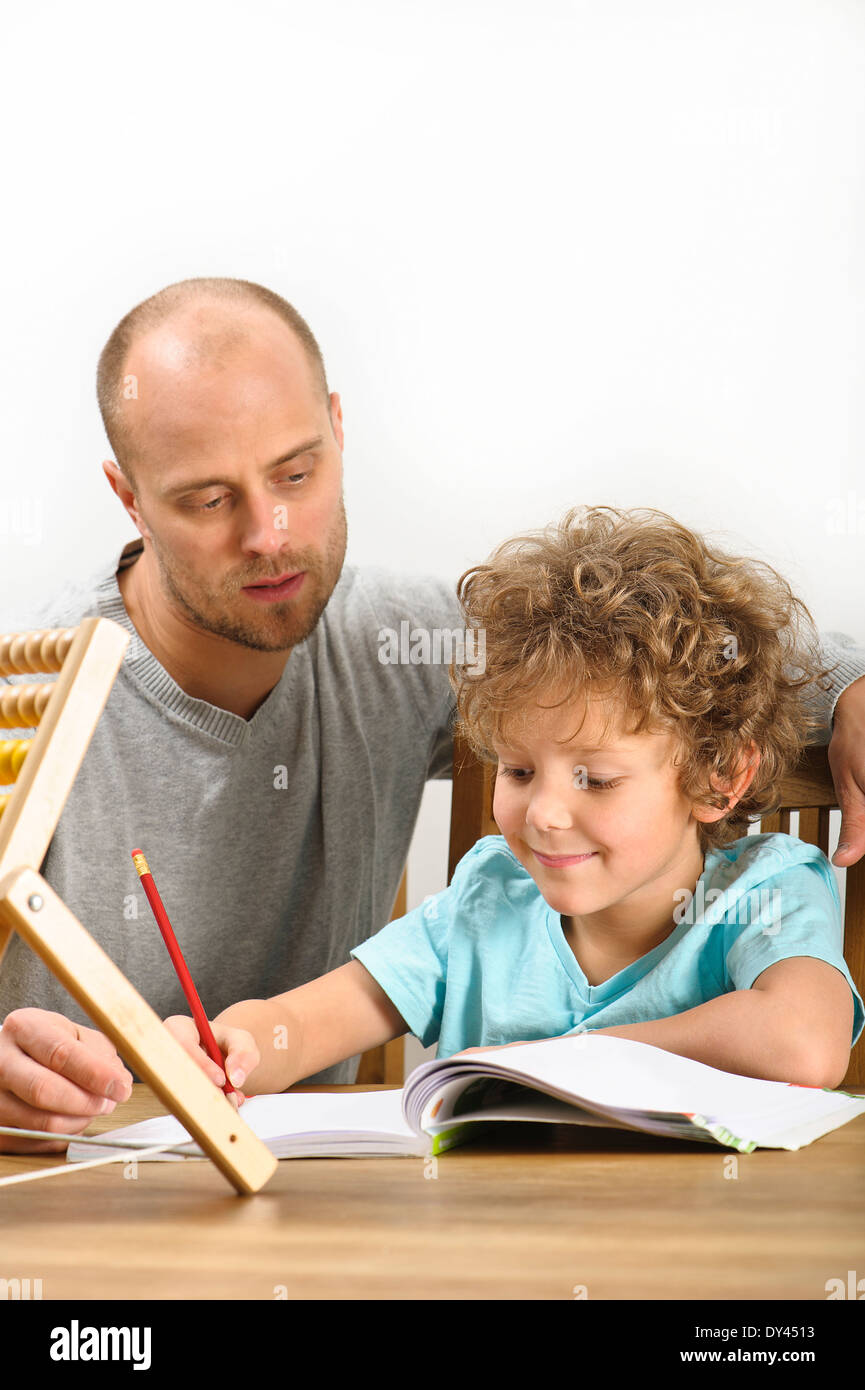 father helping his son with his homework Stock Photo - Alamy