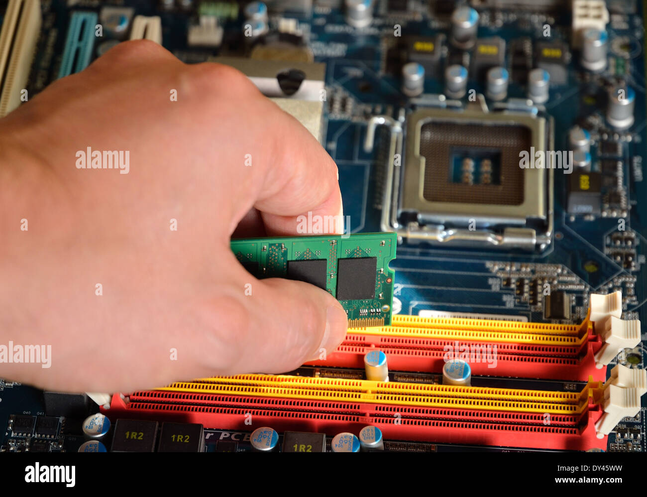 Installing green and black RAM computer memory Stock Photo Alamy