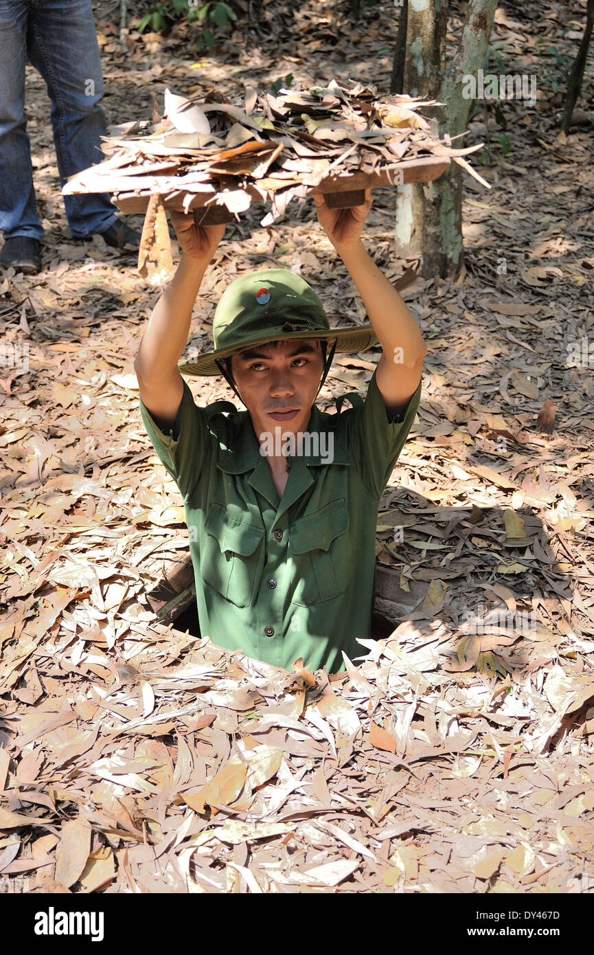 Soldier emerging from Chu Chi Tunnels Saigon Stock Photo