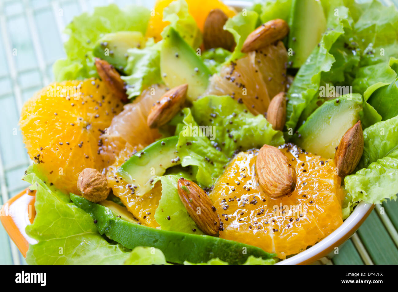 Summery Citrus Salad with almonds and lemon poppy seed dressing Stock Photo
