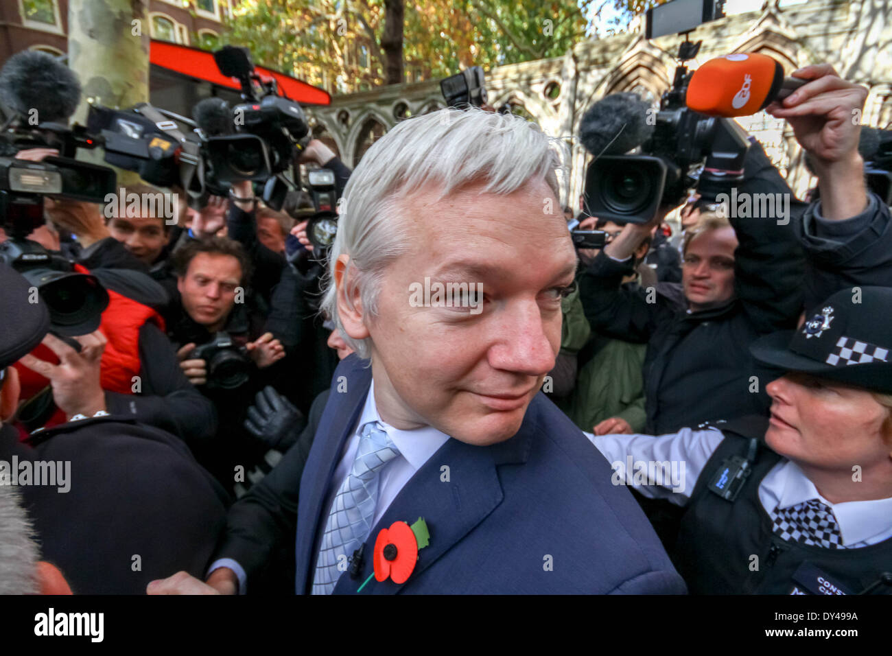 Julian Assange surrounded by international media and under police escort leaves court after losing his extradition appeal. Stock Photo