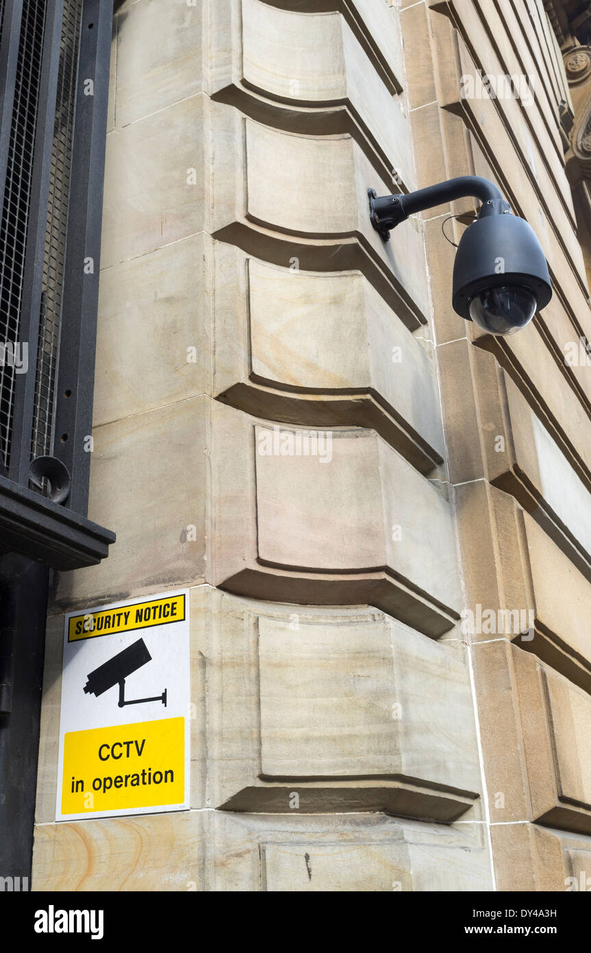 Security CCTV camera and warning sign of the exterior wall of an office building, Glasgow, Scotland, UK Stock Photo