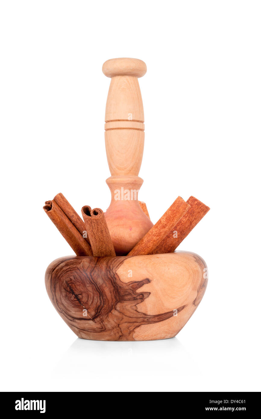 Cinnamon with mortar and pestle isolated on white background Stock Photo
