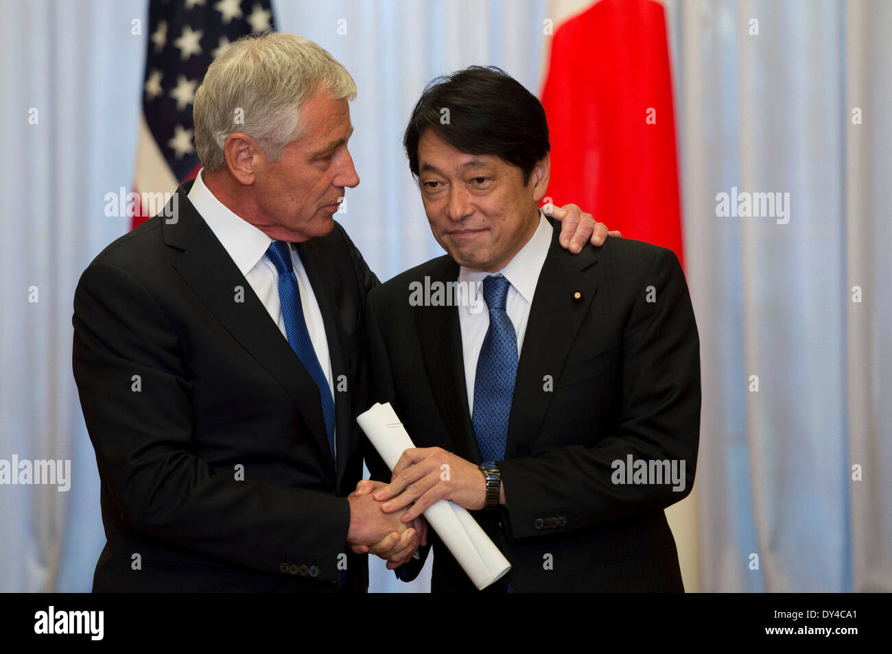 US Secretary of Defense Chuck Hagel greets Japanese Minister of Defense Itsunori Onodera at the Prime Ministers official residence Sori Daijin Kantei April 5, 2014 in Tokyo, Japan. Hagel announced the deployment of drones and missile destroyers to bolster US-Japan defense alliance. Stock Photo