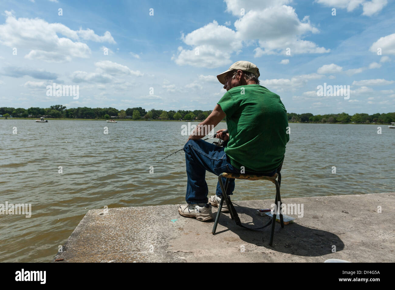Man sitting in chair fishing hires stock photography and images Alamy