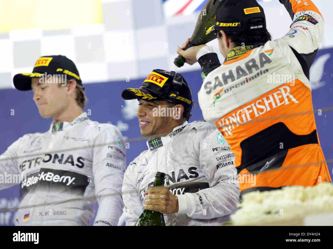 Manama, Bahrain. 06th Apr, 2014. Mercedes' Lewis Hamilton (C), Nico Rosberg (L) and Force India's Sergio Perez celebrate after the final of Formula 1 Bahrain Grand Prix in Manama, Bahrain, on April 6, 2014. Hamilton won the title with 1 hour 39 minutes and 42.743 seconds.  Credit:  Hasan Jamali/Xinhua/Alamy Live News Stock Photo