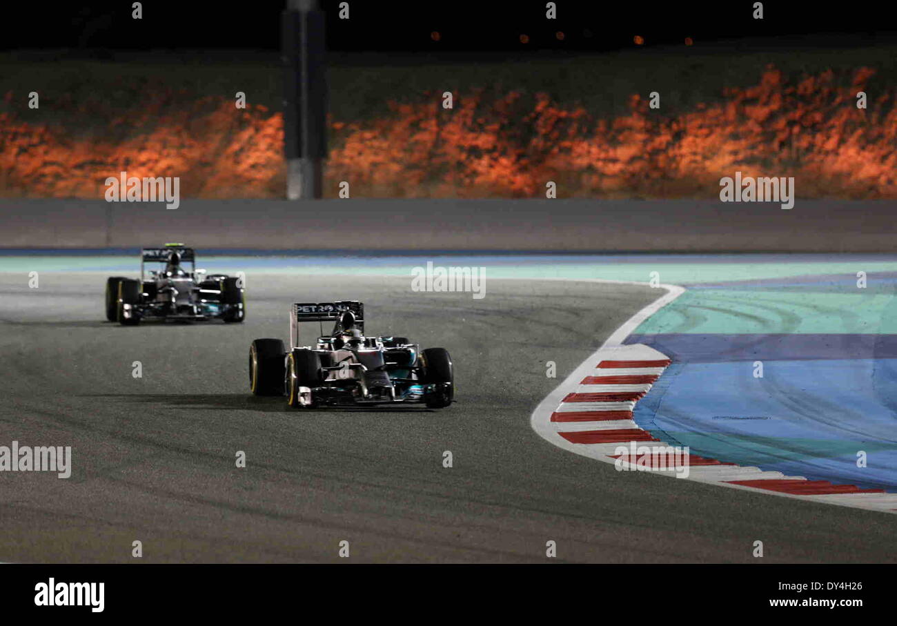 Manama, Bahrain. 06th Apr, 2014. Mercedes' Lewis Hamilton (R) and Nico Rosberg compete during the final of Formula 1 Bahrain Grand Prix in Manama, Bahrain, on April 6, 2014. Hamilton won the title with 1 hour 39 minutes and 42.743 seconds.  Credit:  Hasan Jamali/Xinhua/Alamy Live News Stock Photo