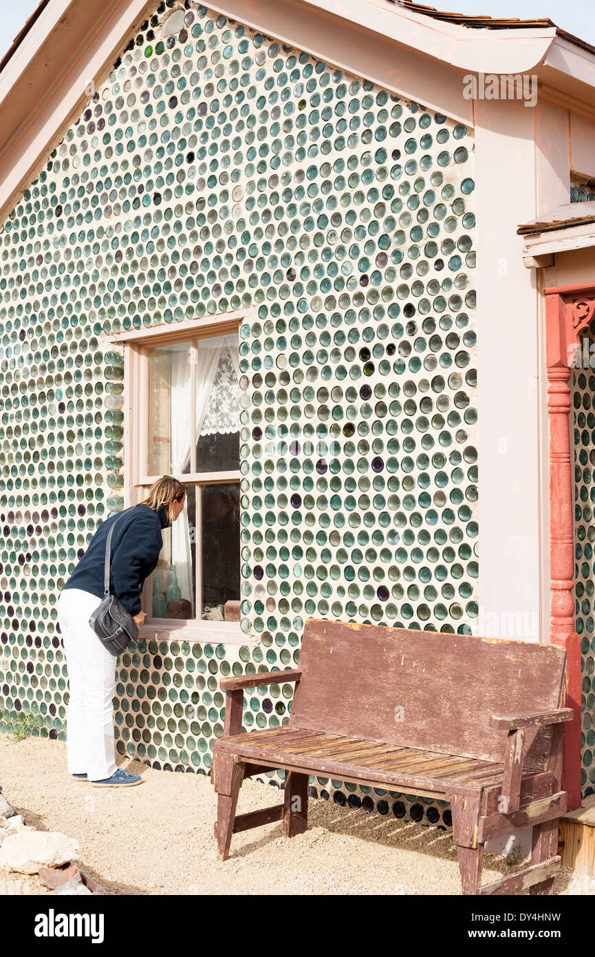 A woman admires the famous Bottle House in the ghost town of Rhyolite