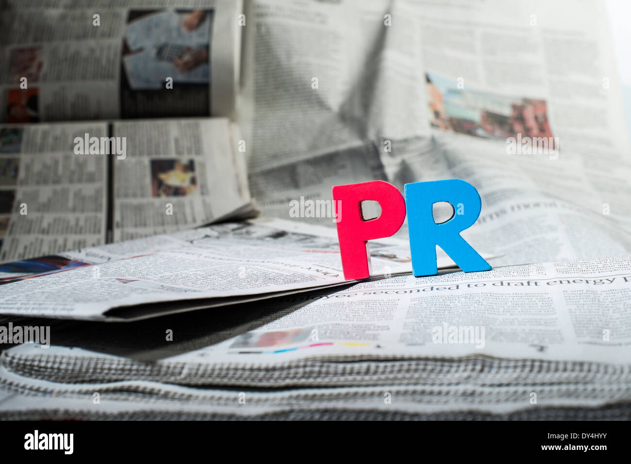 Word PR on newspaper. Wooden letters Stock Photo