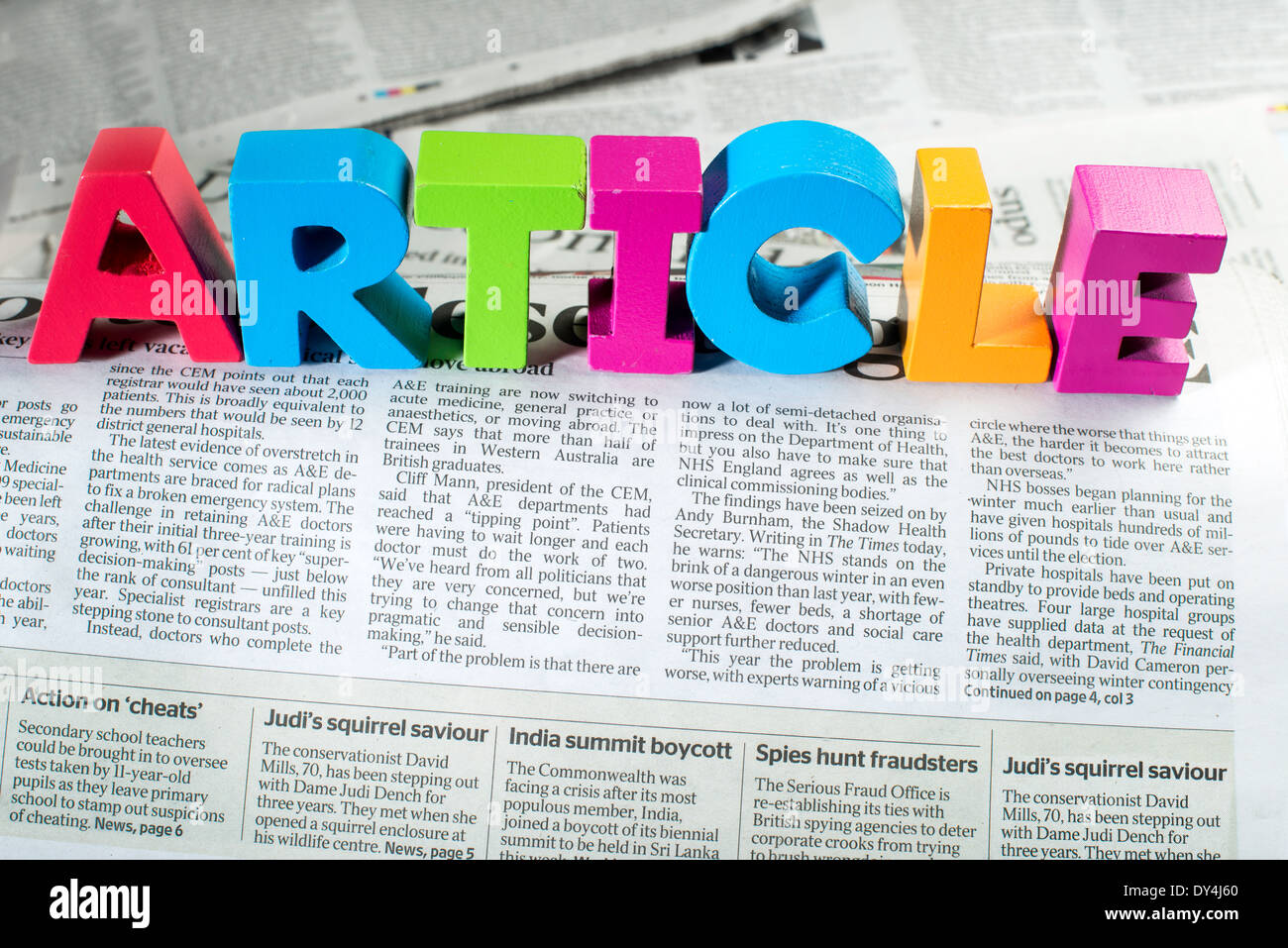 Word article on newspaper. Wooden letters Stock Photo