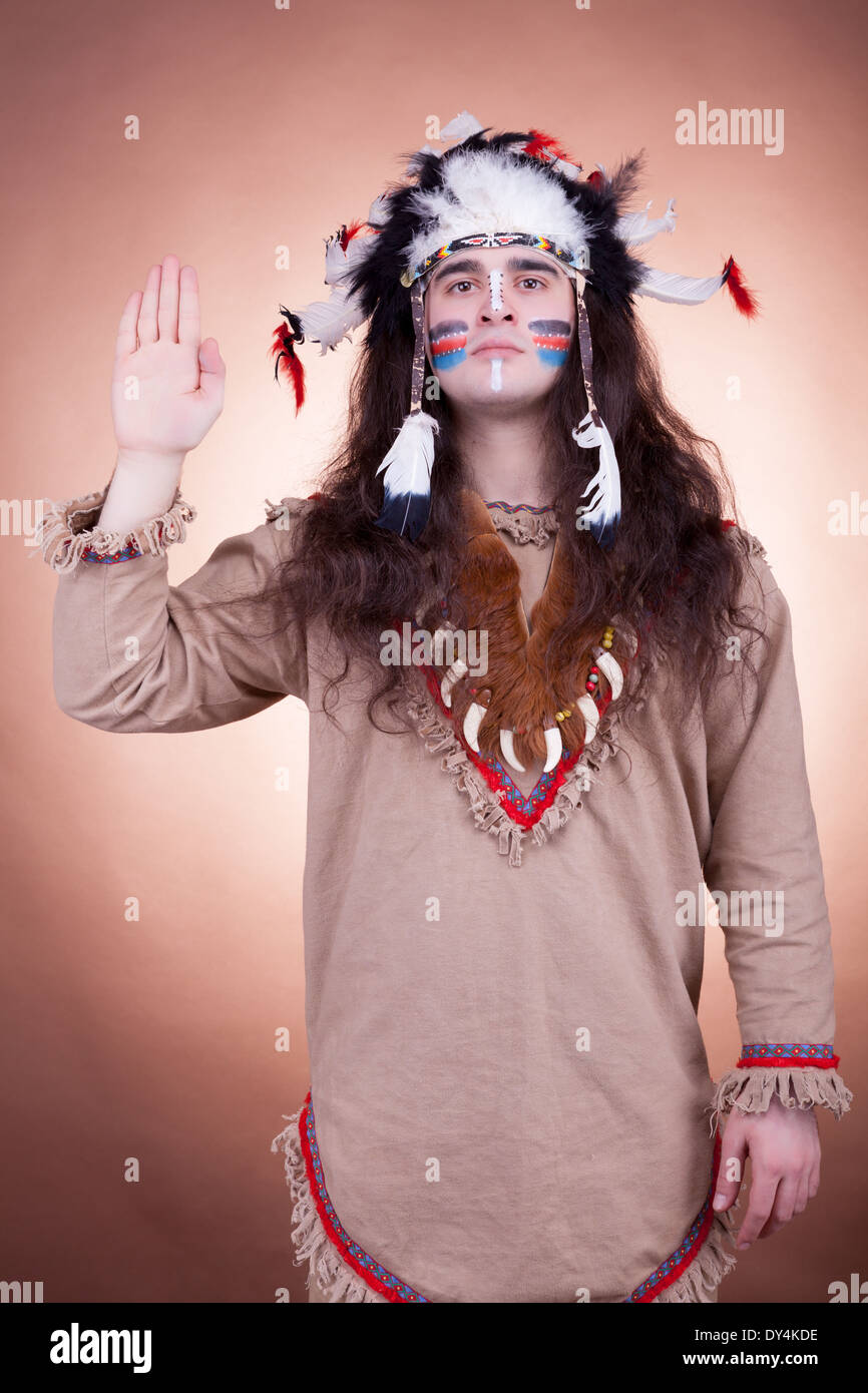 Native american men greeting on brown background. Studio shooting Stock