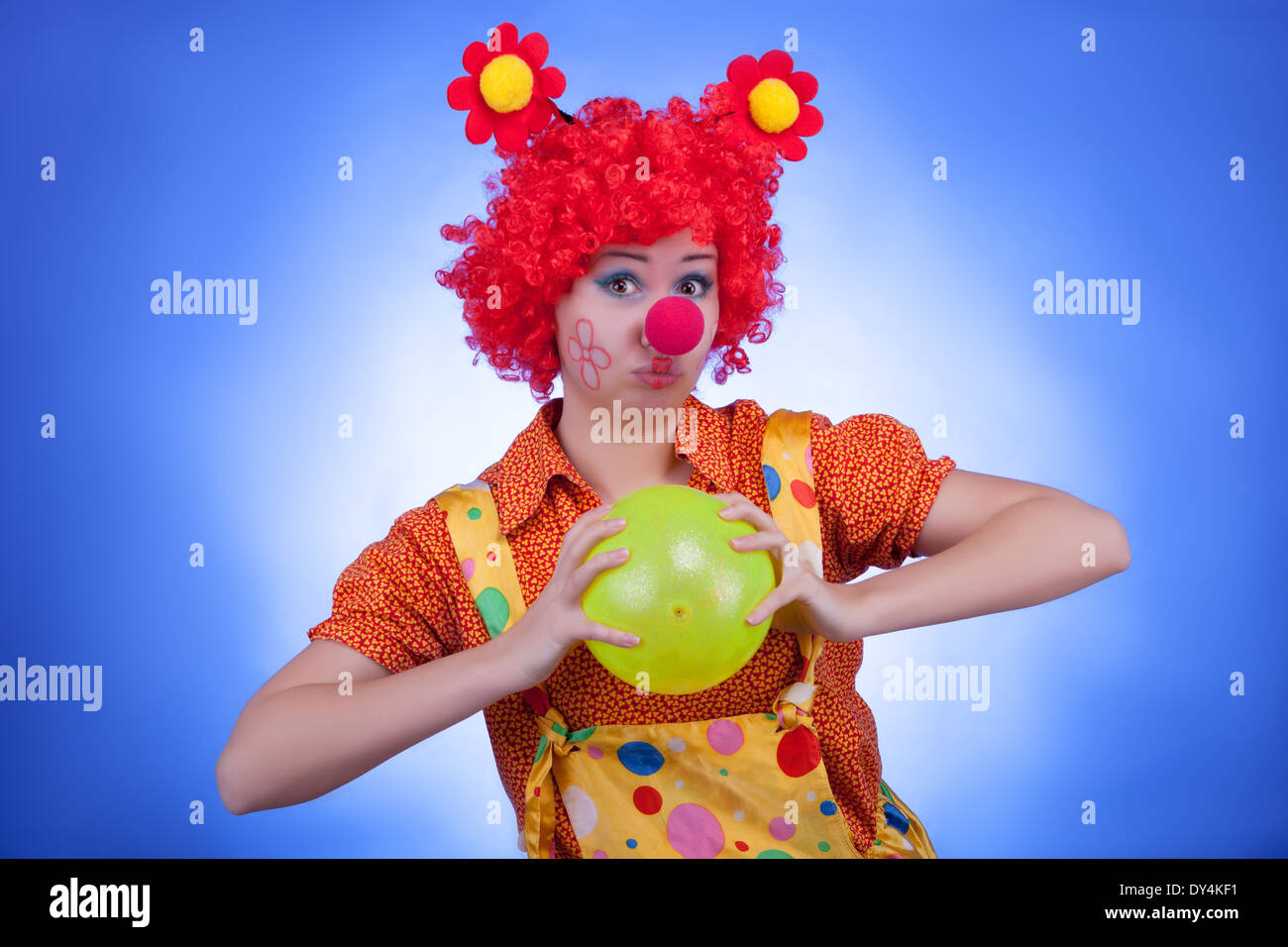Happy clown on blue background. Studio shooting Stock Photo