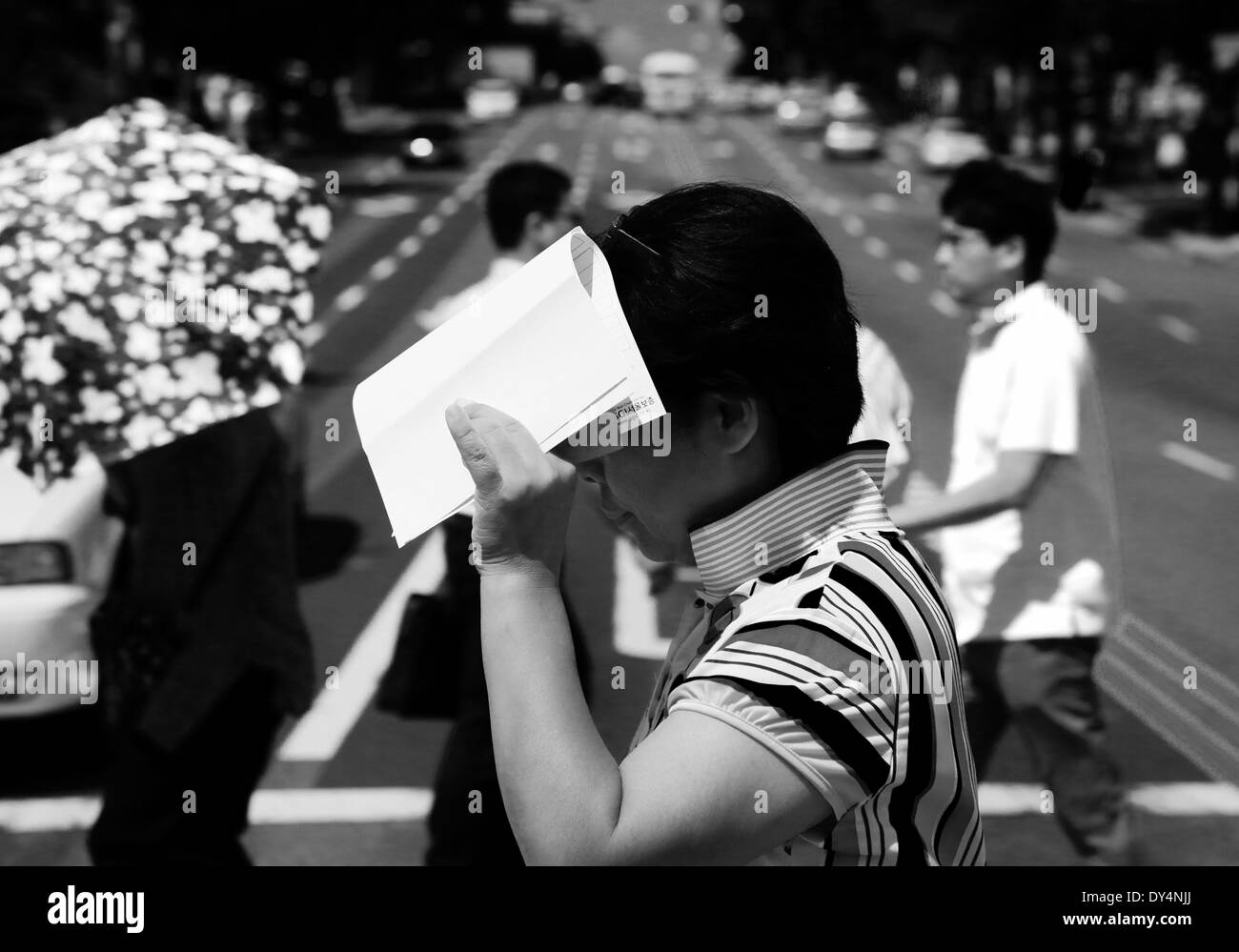 Seoul South Korea woman protecting face from sun Stock Photo