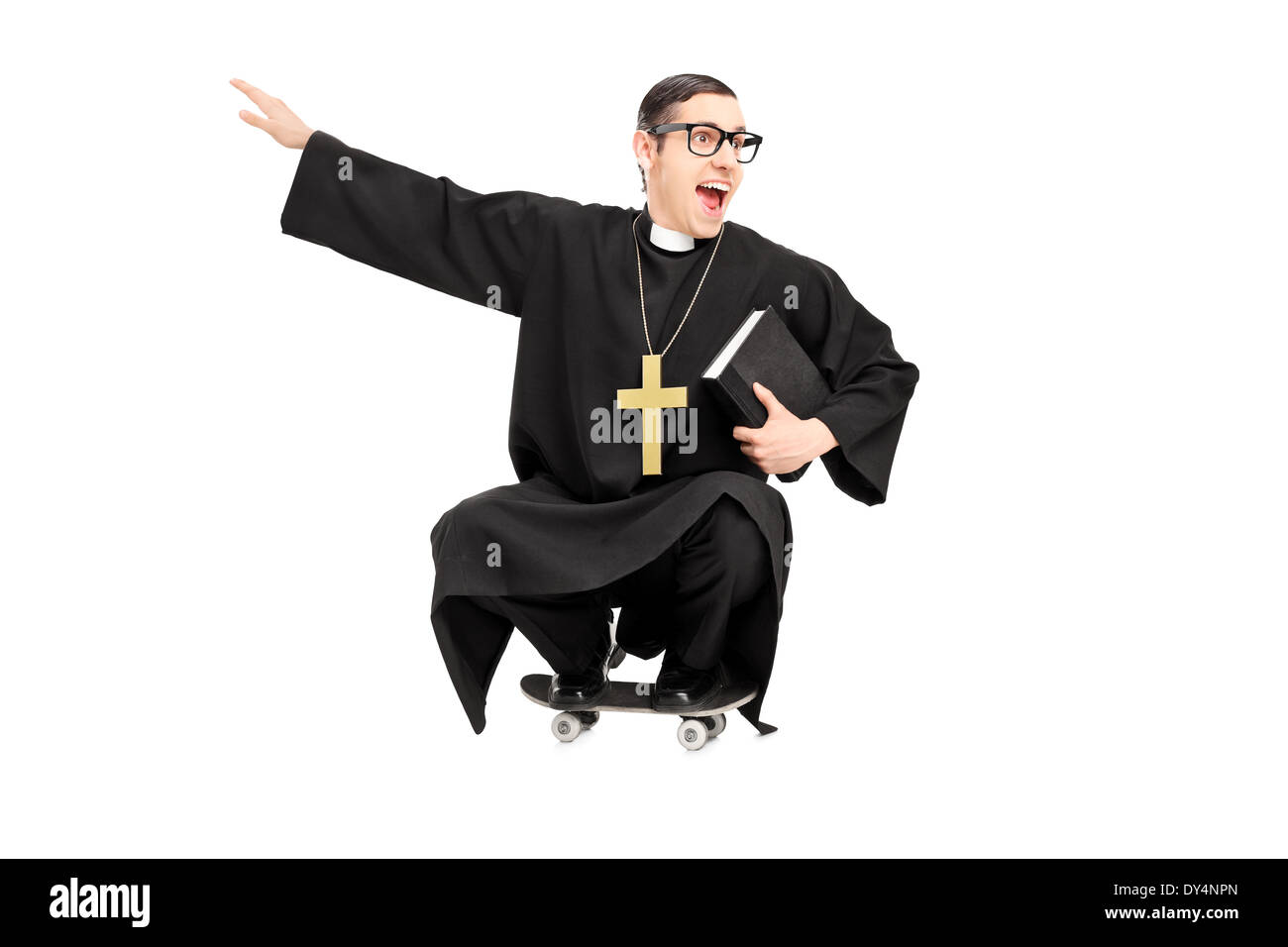 Silly priest riding a small skateboard Stock Photo