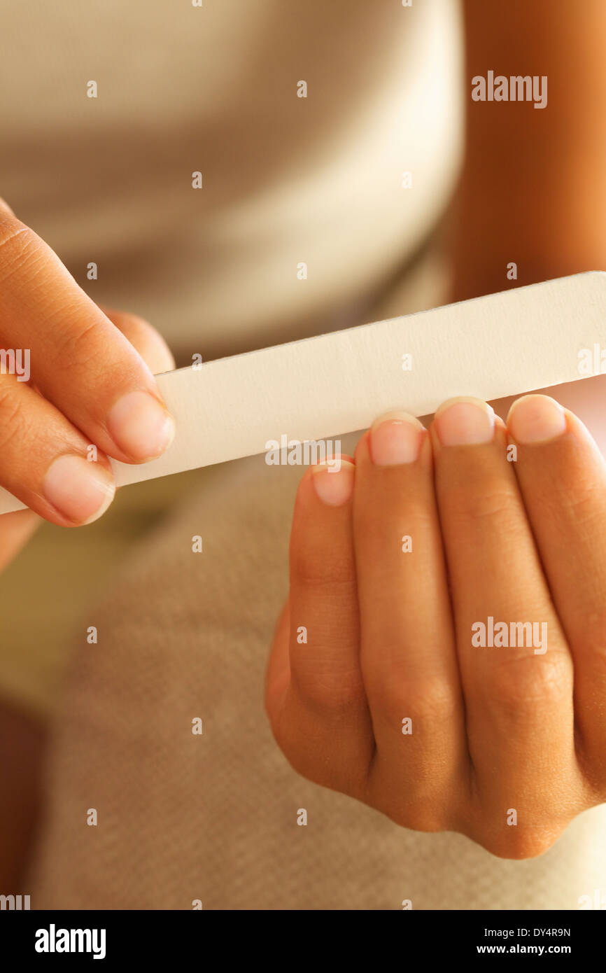 Woman Filing Fingernails, Close-up View Stock Photo