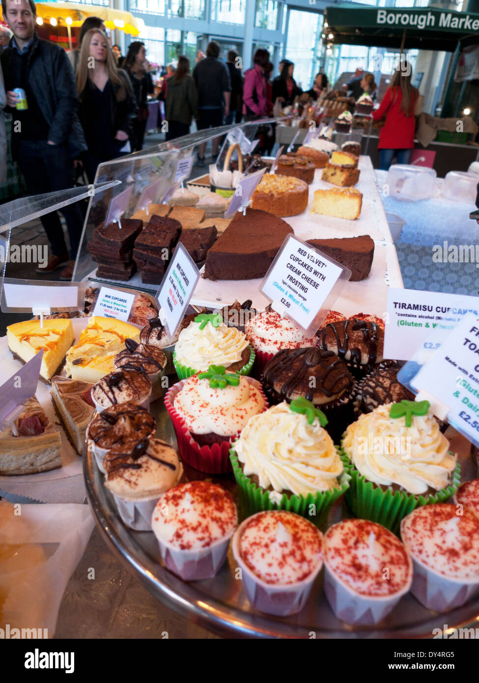 Display of decorated cupcakes with frosting icing for sale on cake