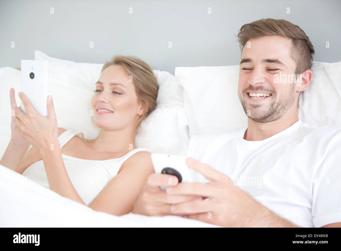 Male couple reclining and laughing hires stock photography and images