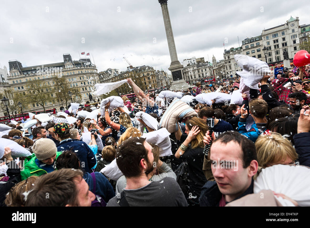 People gathering in Trafalgar Square to participate in the International Pillow Fight Day. Stock Photo