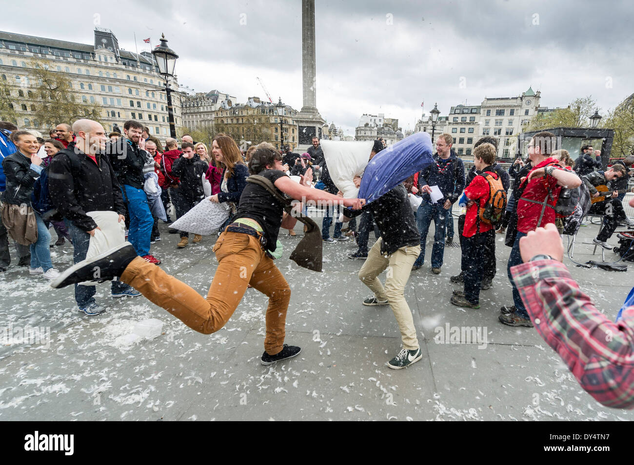 People gathering in Trafalgar Square to participate in the International Pillow Fight Day. Stock Photo