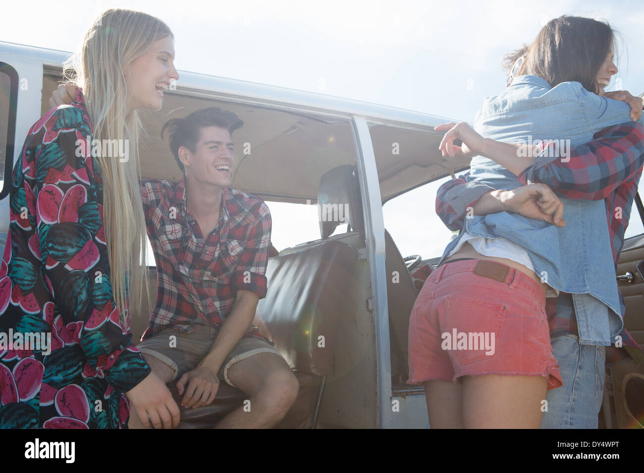 Friends hugging by campervan Stock Photo