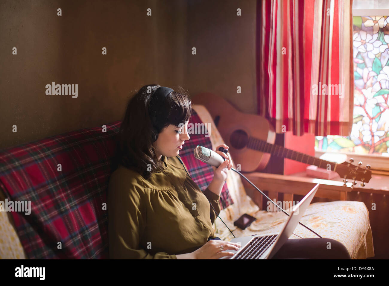 Woman headphones laptop singing microphone hires stock photography and