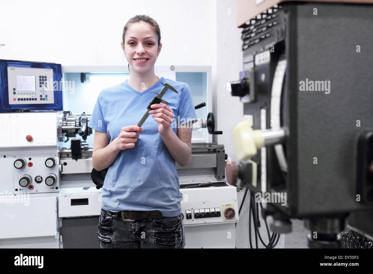 Portrait of female engineer holding tool Stock Photo