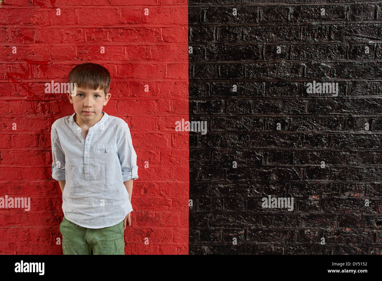 Boy against red and black wall Stock Photo
