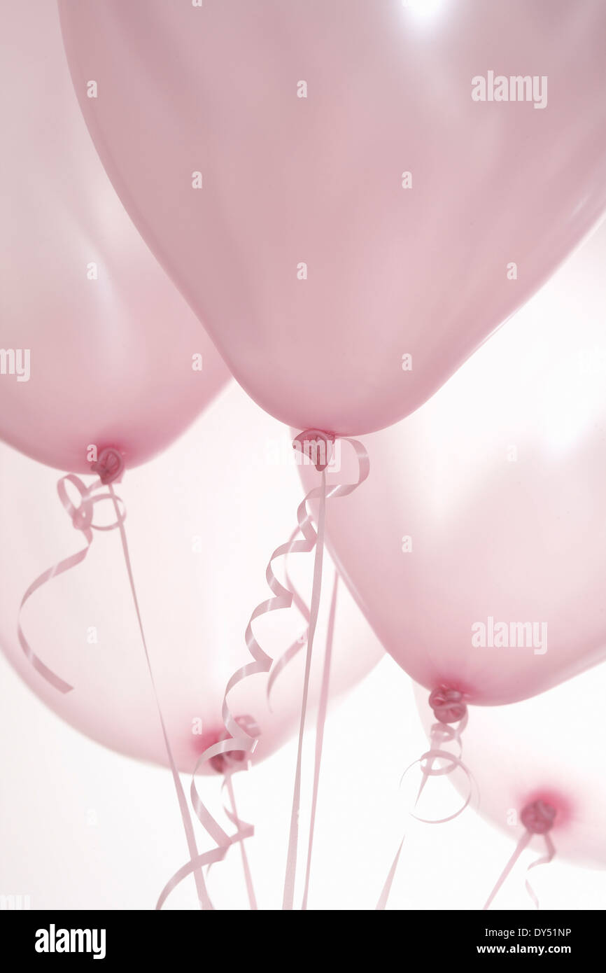 Shiny decorative ribbons hanging from helium balloons Stock Photo