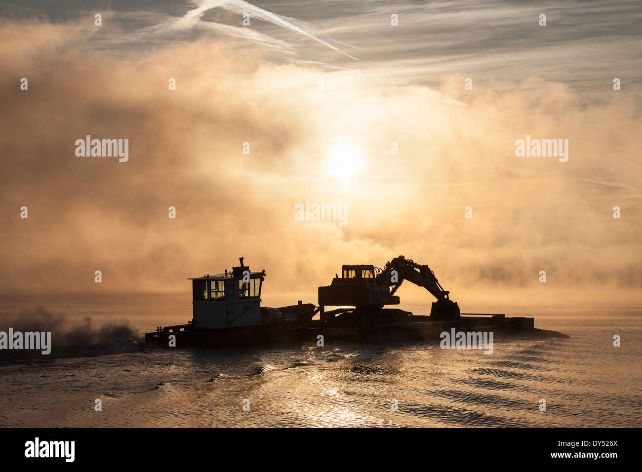 Silhouette of excavator on barge, Lake Maggiore, Stresa, Piemonte, Italy Stock Photo