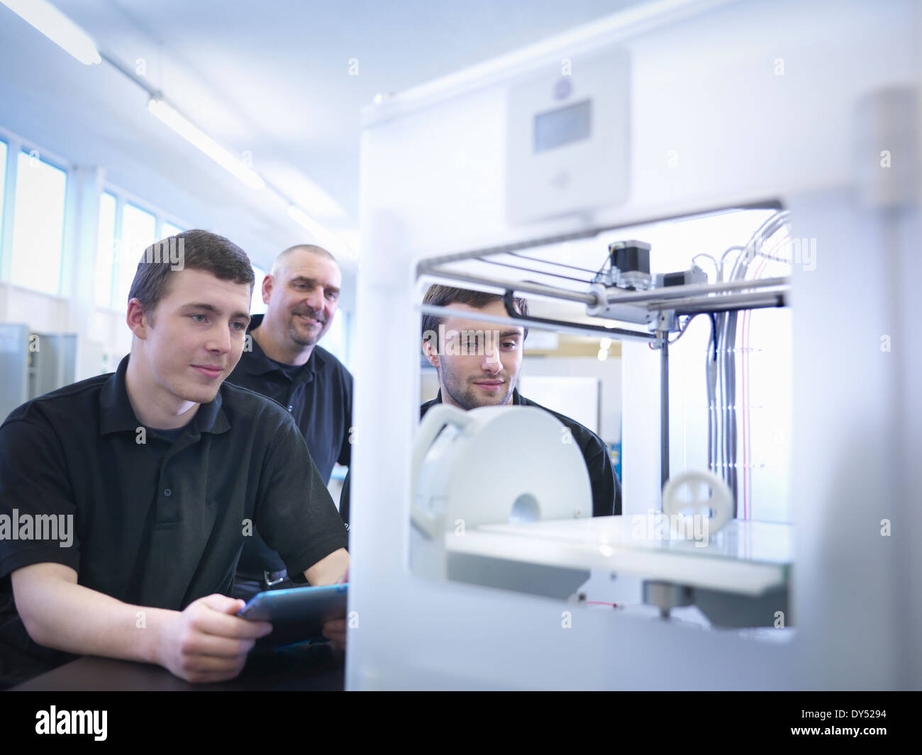 Instructor with apprentices and 3D printing machine Stock Photo