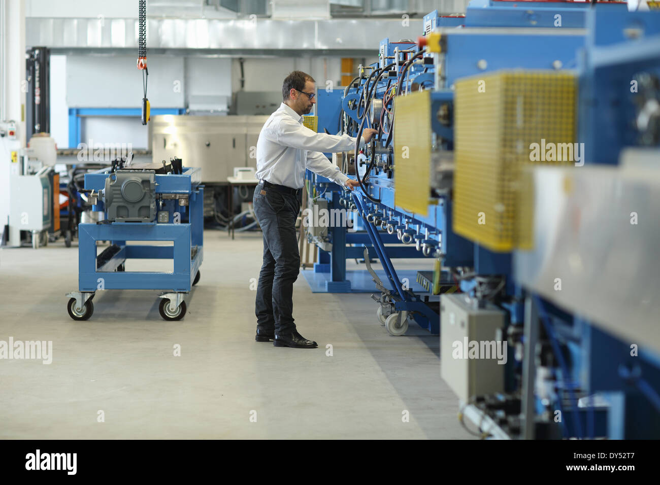 Manager checking industrial machinery Stock Photo