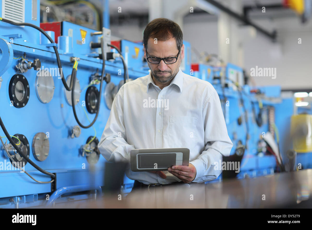Technical manager checking information on digital tablet Stock Photo
