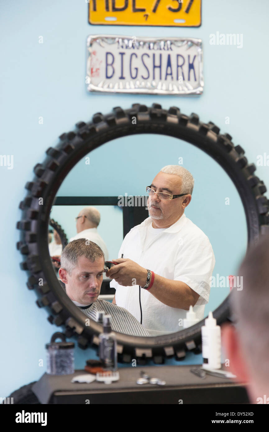 Barber shaving man's hair Stock Photo Alamy