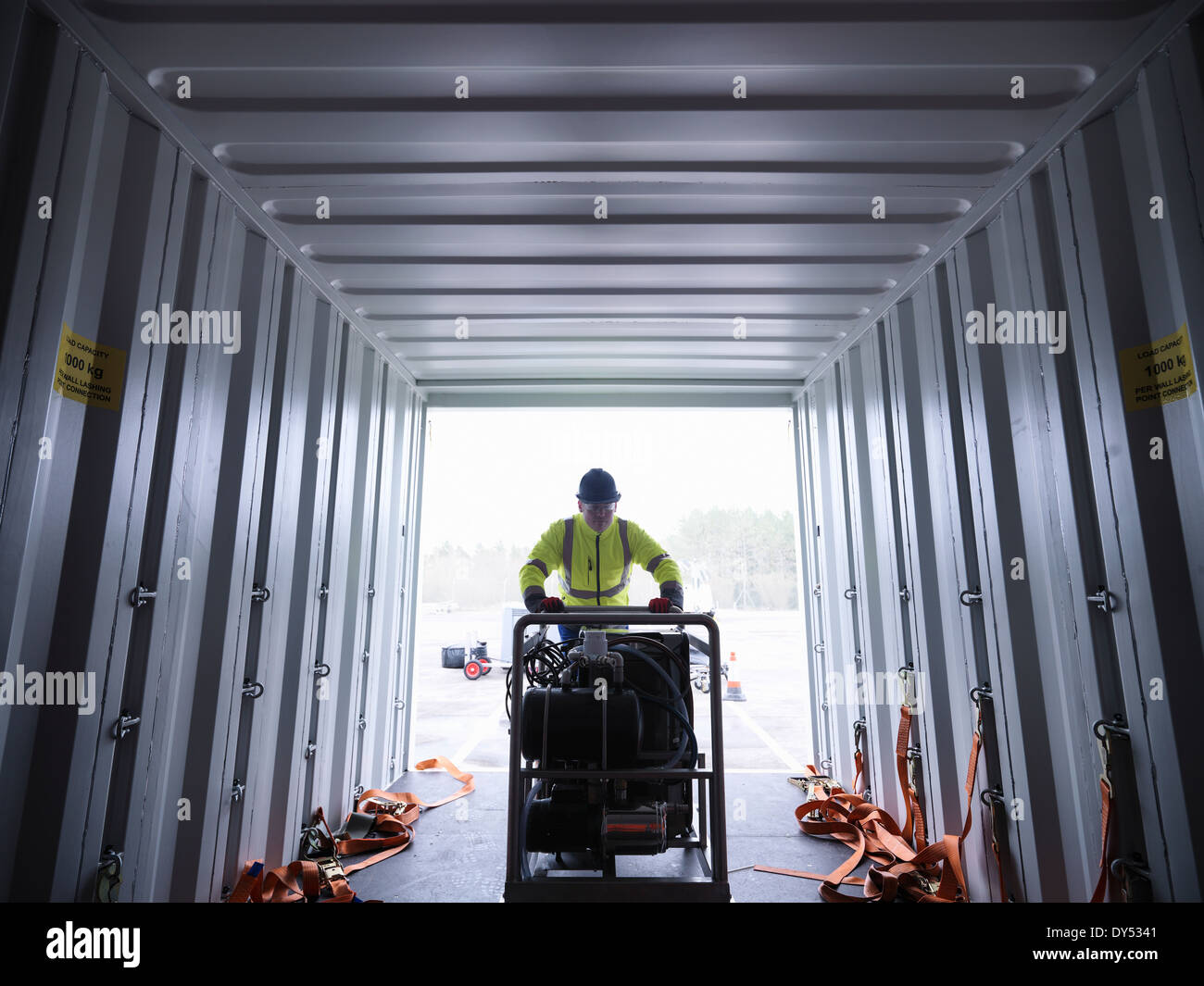 Emergency Response Team worker unloads equipment from shipping container Stock Photo