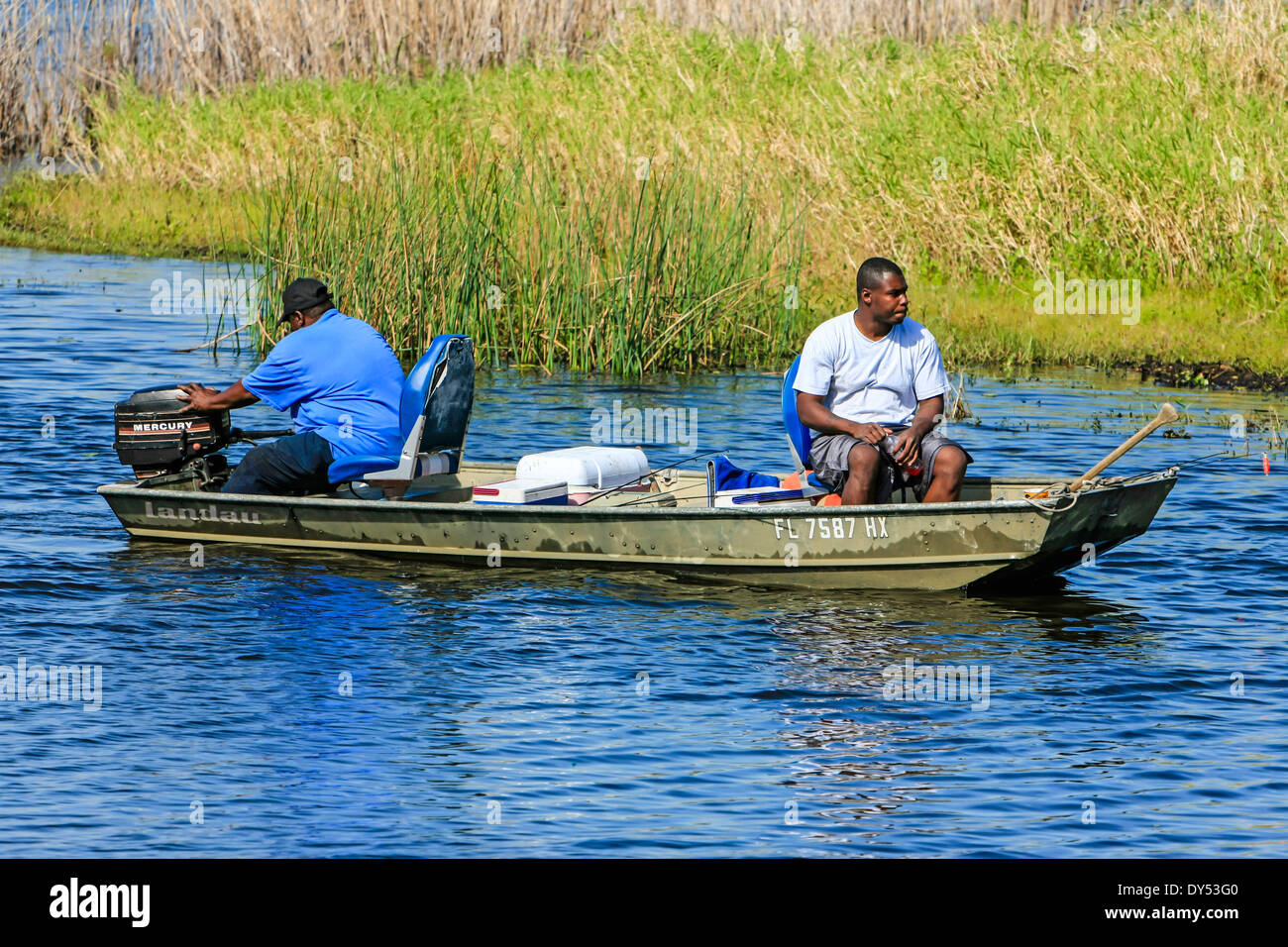 Two African-American Men fishing from their boat the waters in