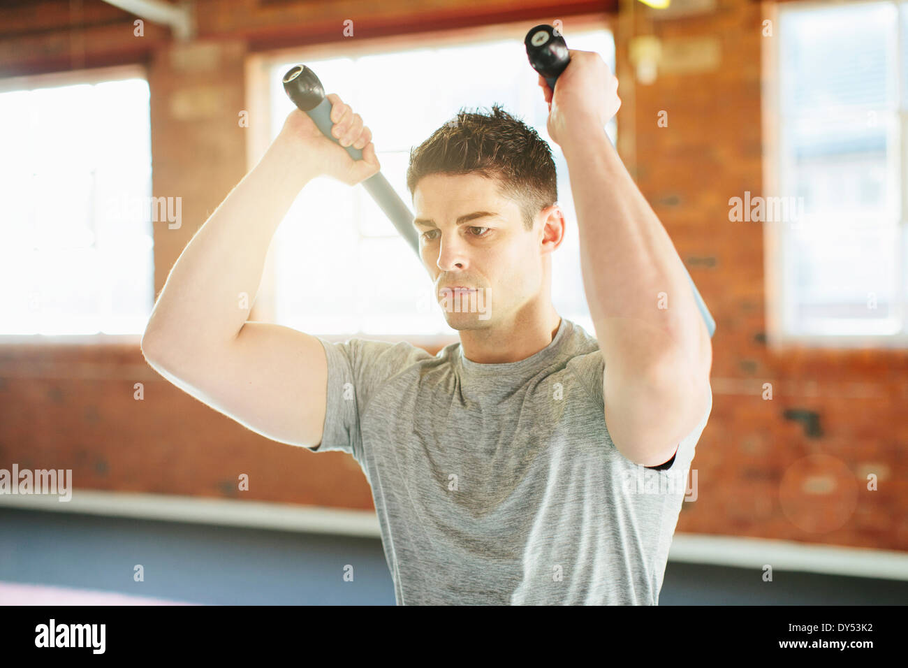 Man lifting weights in gymnasium Stock Photo