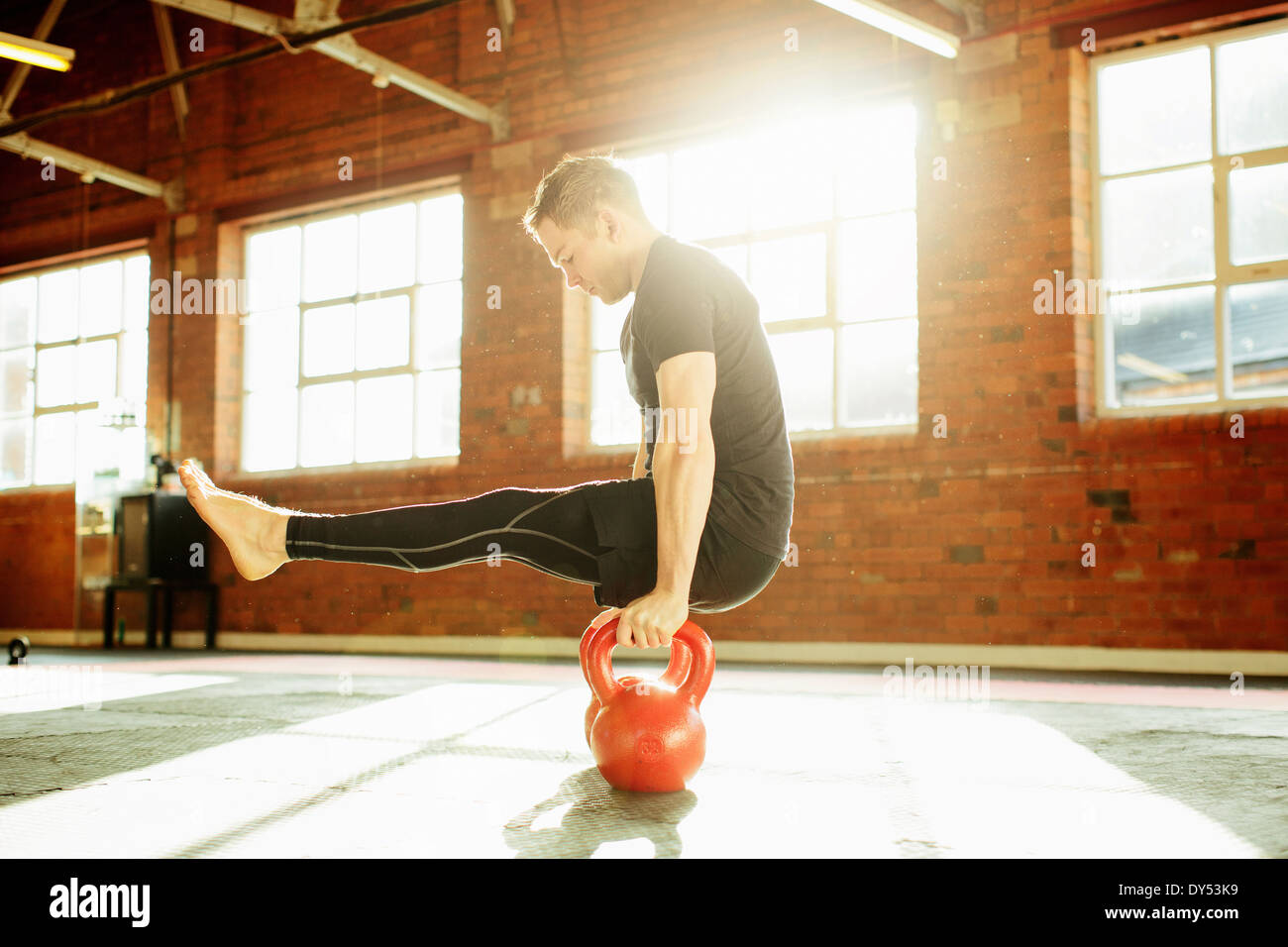 Man strength training with kettle bells Stock Photo