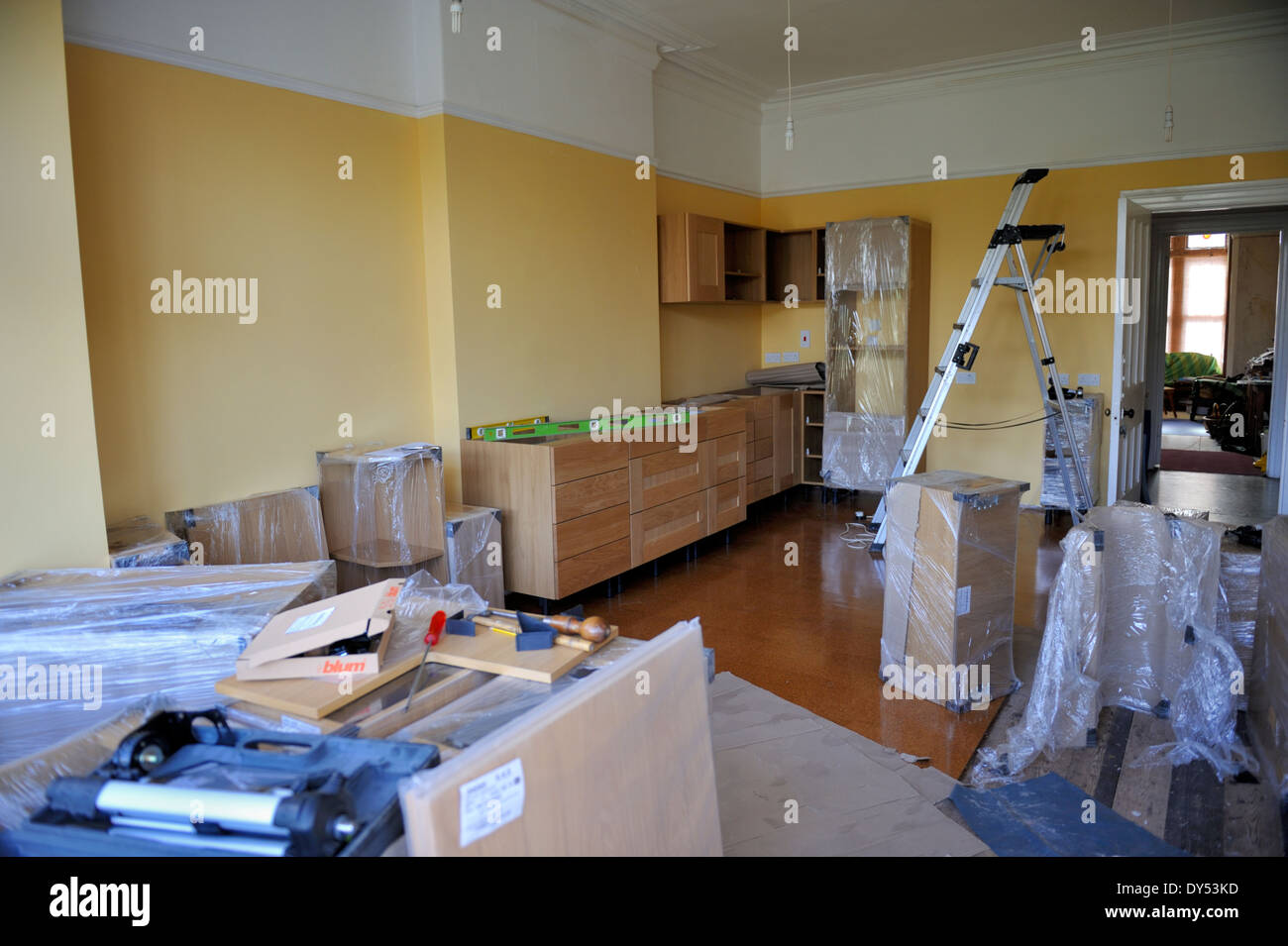 Building a kitchen from ready made units. Laying out, installing and levelling at the start. Stock Photo