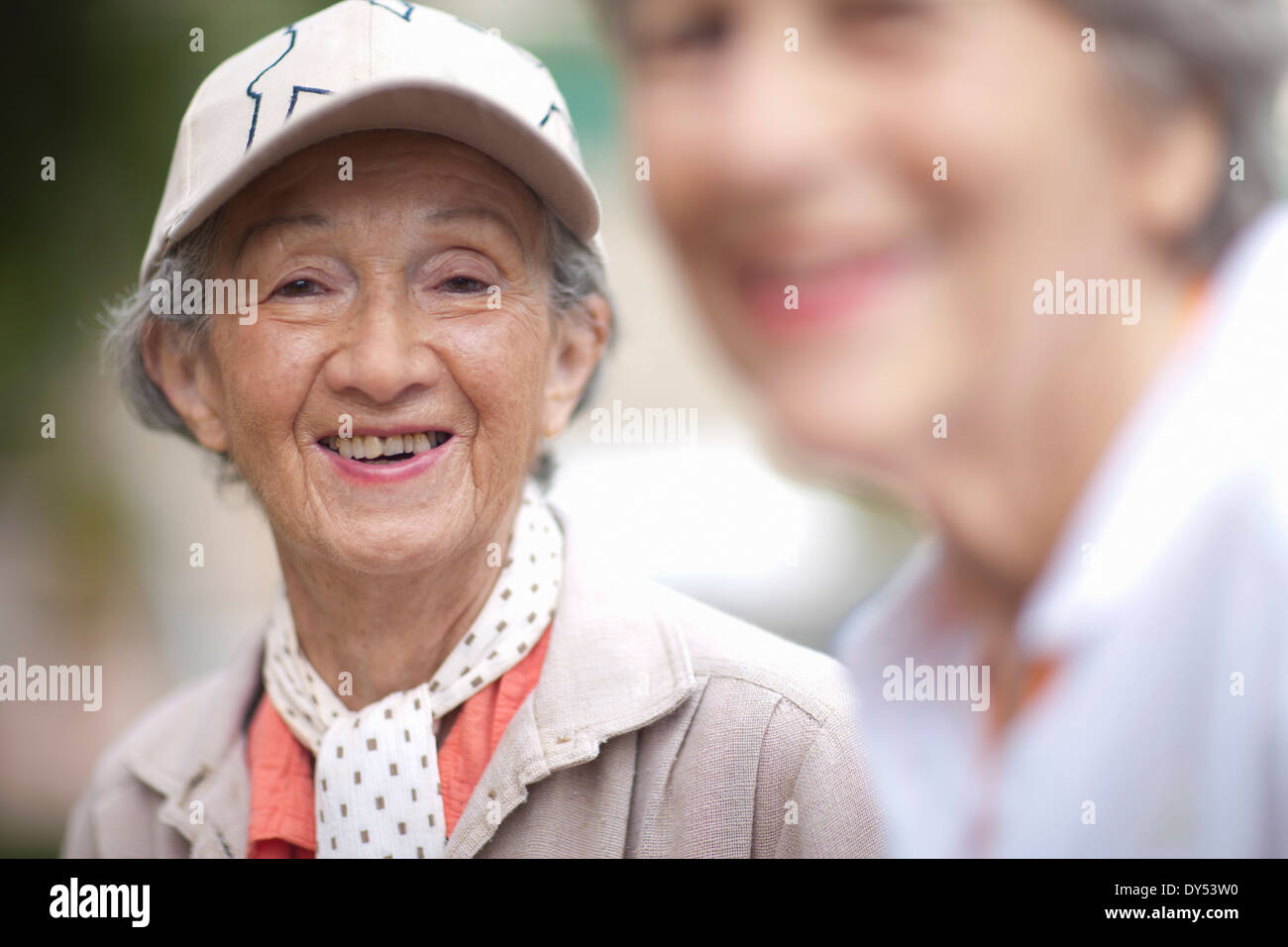 Two senior women talking in retirement villa garden Stock Photo