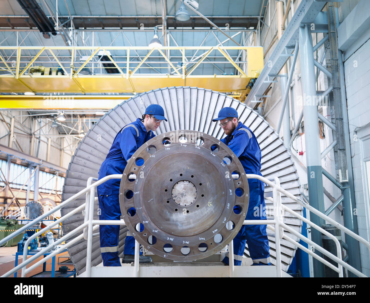 Engineers repairing steam turbine in workshop Stock Photo