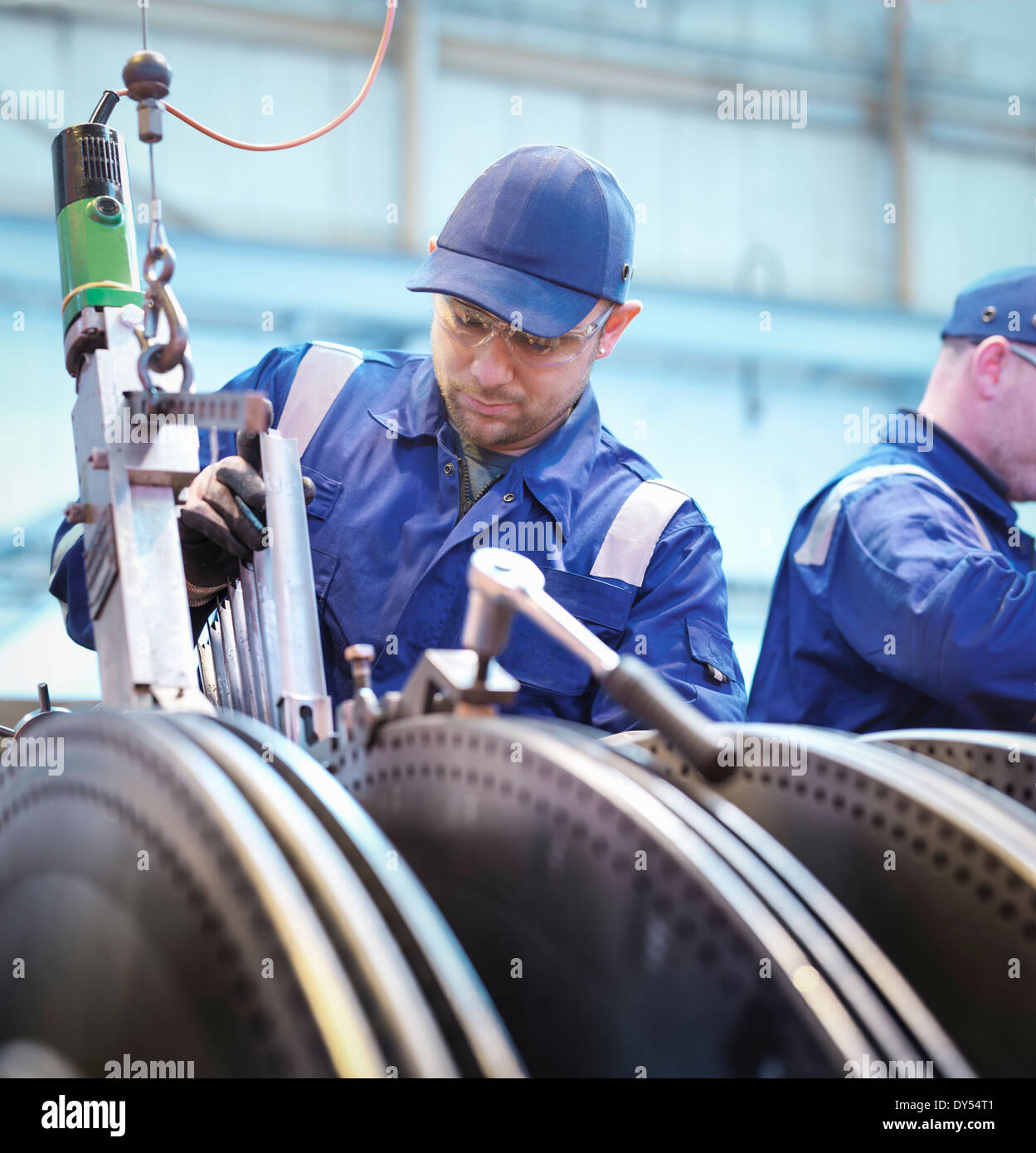 Engineers fitting blades to steam turbine in repair works Stock Photo