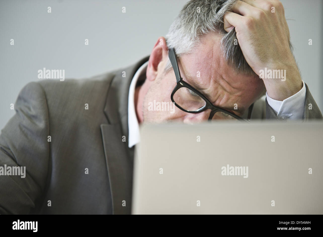 Stressed mature businessman in office Stock Photo