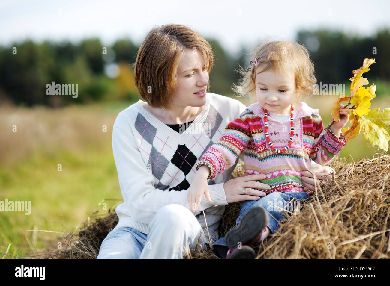 Young mother and her toddler girl in autumn fields Stock Photo - Alamy