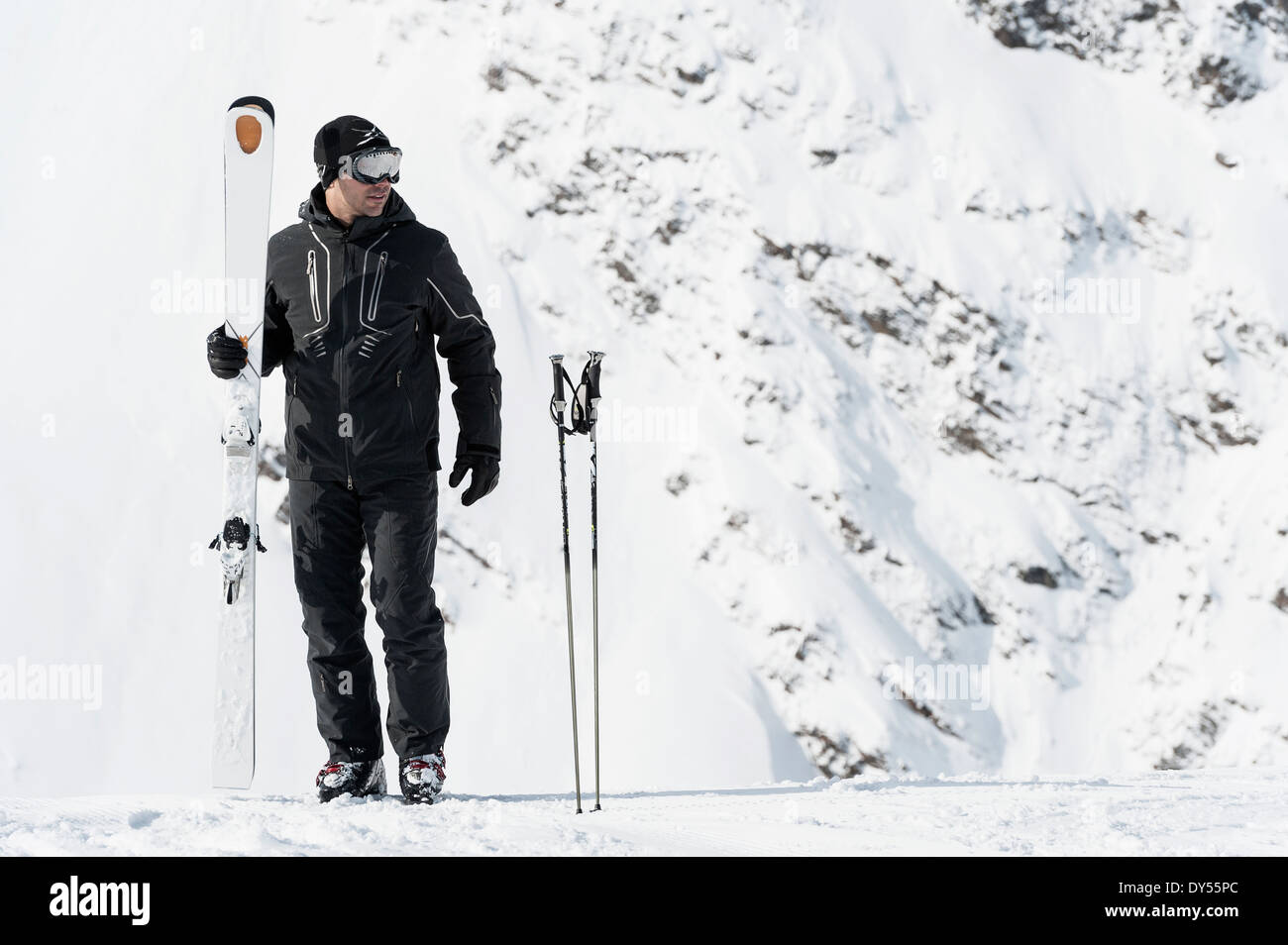 Portrait of mid adult man holding skis, Obergurgl, Austria Stock Photo