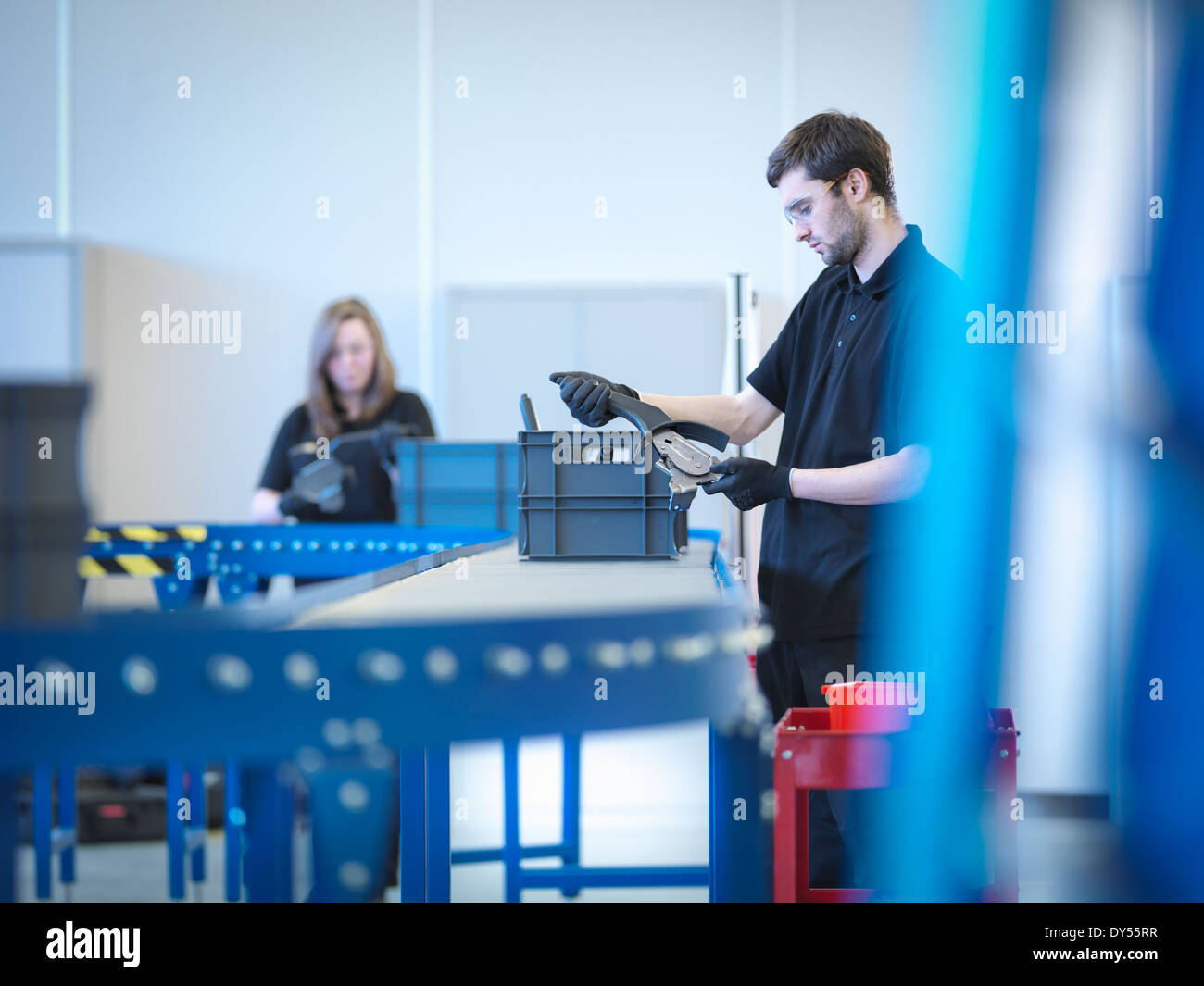 Apprentices working on training production line Stock Photo