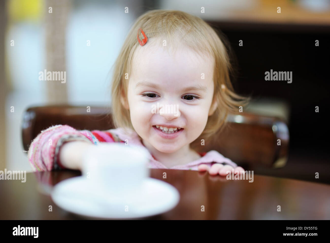 Adorable smiling toddler girl at indoor cafe Stock Photo Alamy
