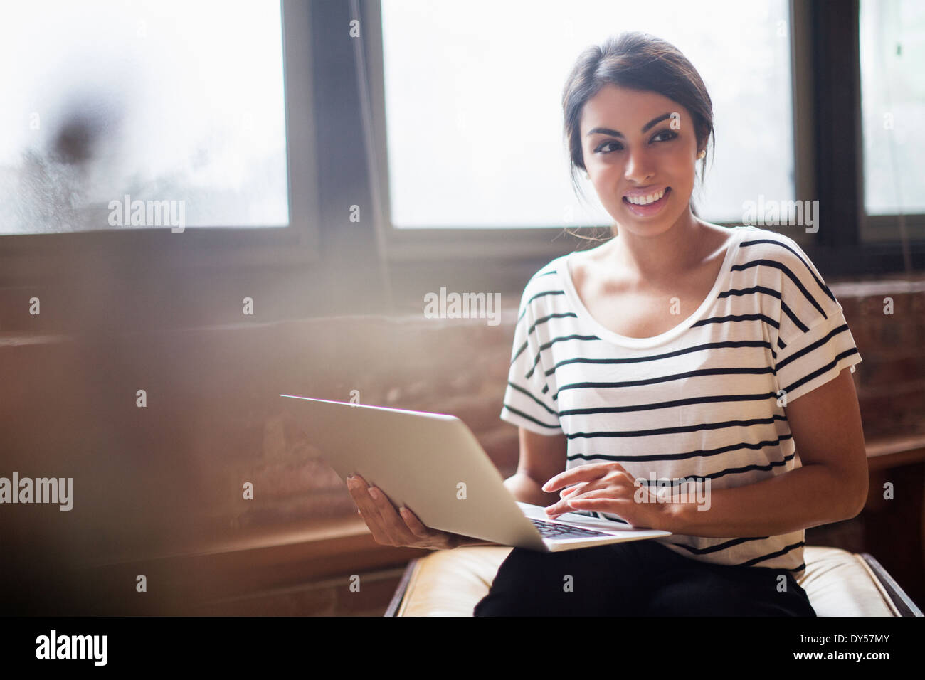 Young woman using laptop computer Stock Photo