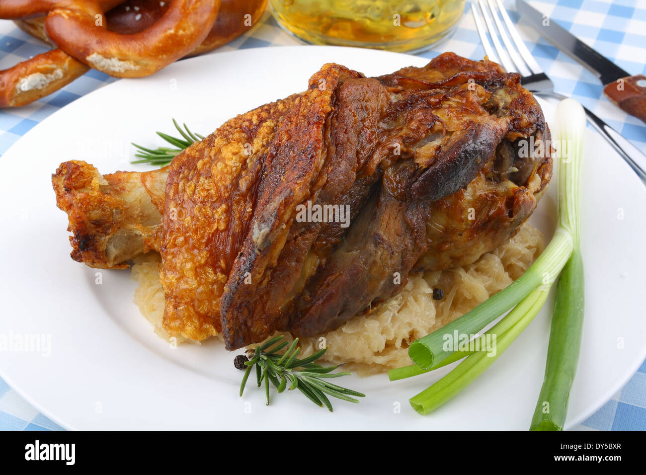 Grilled pork hock with sauerkraut, pretzels, beer, top view Stock Photo