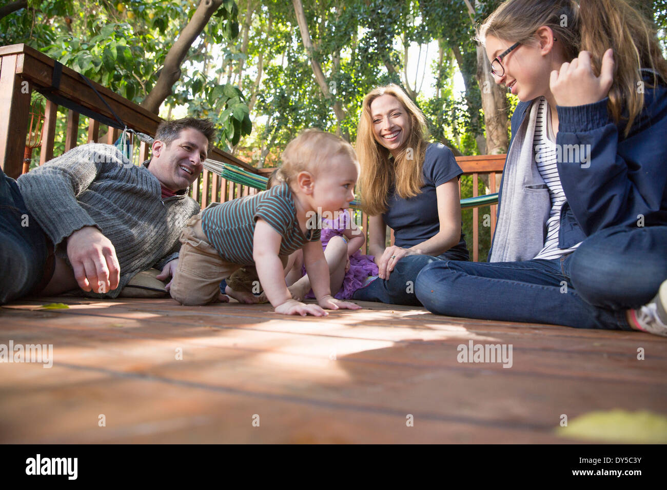 Family relaxing on porch Stock Photo - Alamy