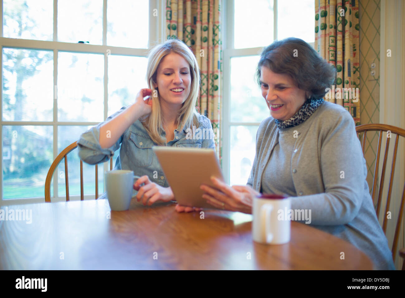 Senior woman and granddaughter looking at digital tablet Stock Photo